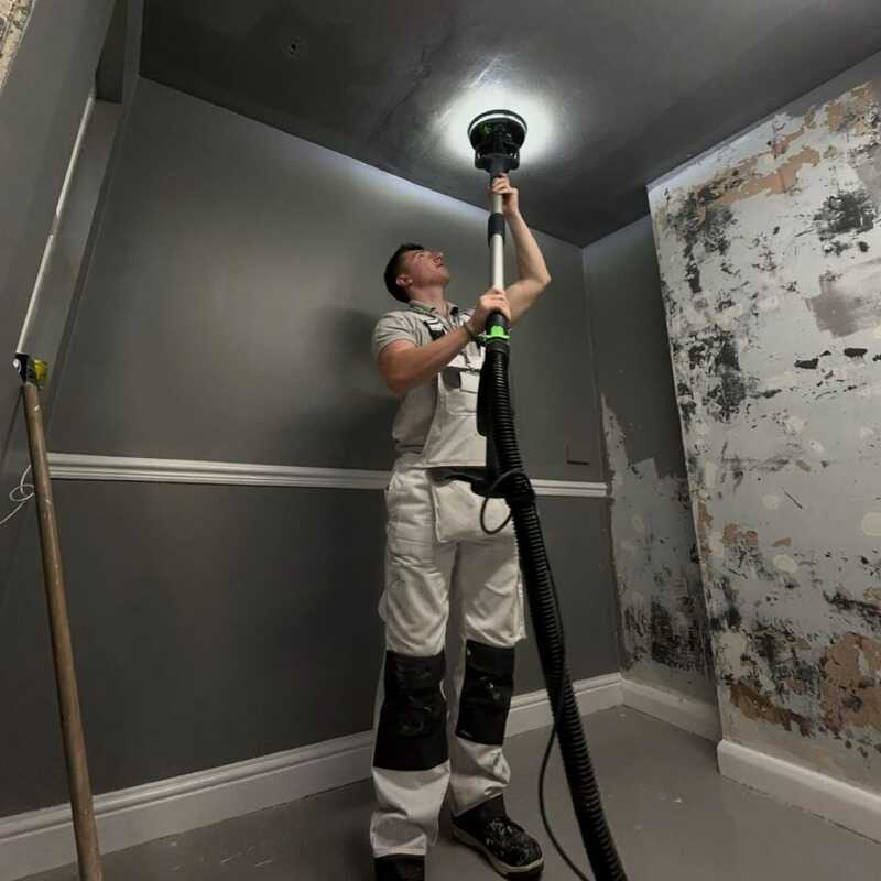 Kian from KRT Painting and Decorating at work on a ceiling